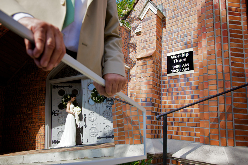Jennifer Sirmon is reflected in a mirror held by her father, Joel Sirmon, as she takes a peek into Fairhope United Methodist Church, before the start of the ceremony in which she married Jeff Peters, July 20, 2009, in Fairhope, Ala.