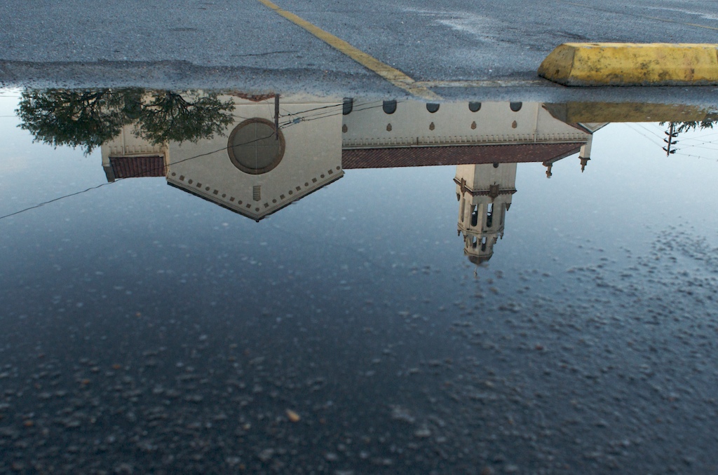St. Mary's Catholic Church is reflected in a water puddle in its parking lot in Mobile, Ala., Sunday evening, Sept. 20, 2009.