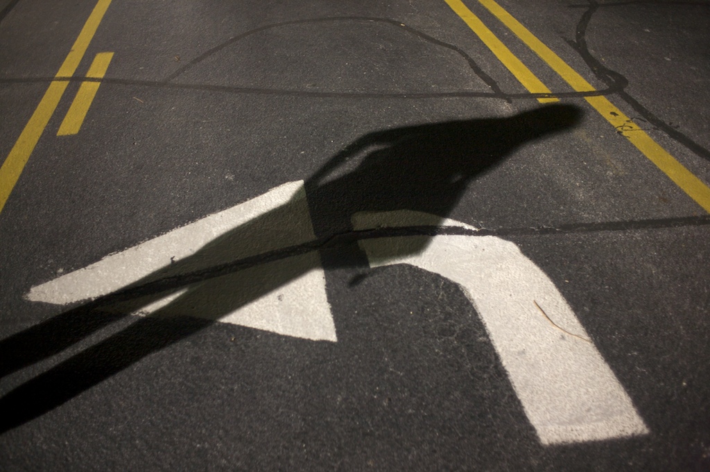 A shadow is cast across a turning lane arrow at the University of South Alabama in Mobile, Ala., Wednesday night, Oct. 14, 2009.