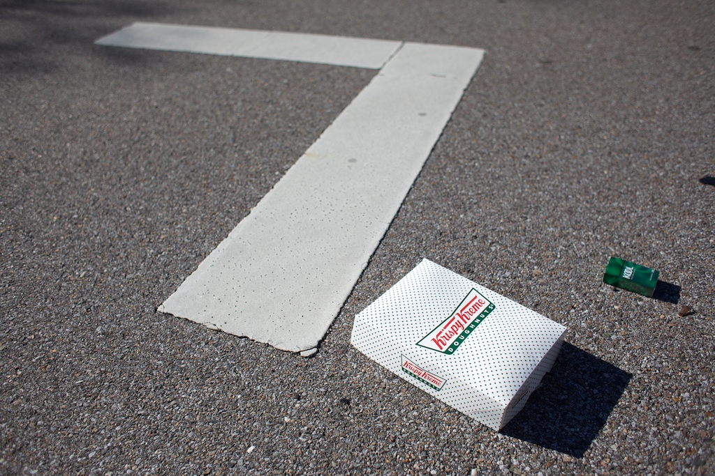 A Krispy Kreme doughnut box and a Kool cigarette box lie in the street in Mobile, Ala., Saturday, Nov 14, 2009.