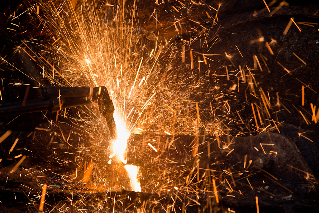 Sparks fly as scrap metal is cut into smaller chunks at Royal Street Junk in Mobile, Ala., Tuesday, Nov. 10, 2009.