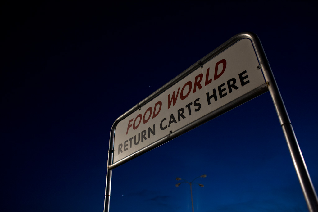 A sign in the Food World parking lot indicates where guests should return their carts to.