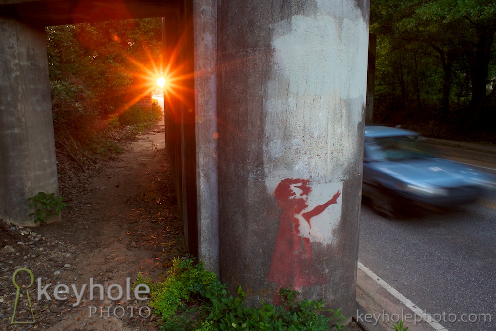 The sun sets behind the railroad overpass bridge on Old Shell Road in Mobile, Ala., Wednesday, May 5, 2010.
