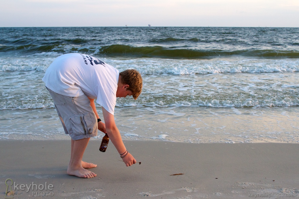 Picking up oil on the beach