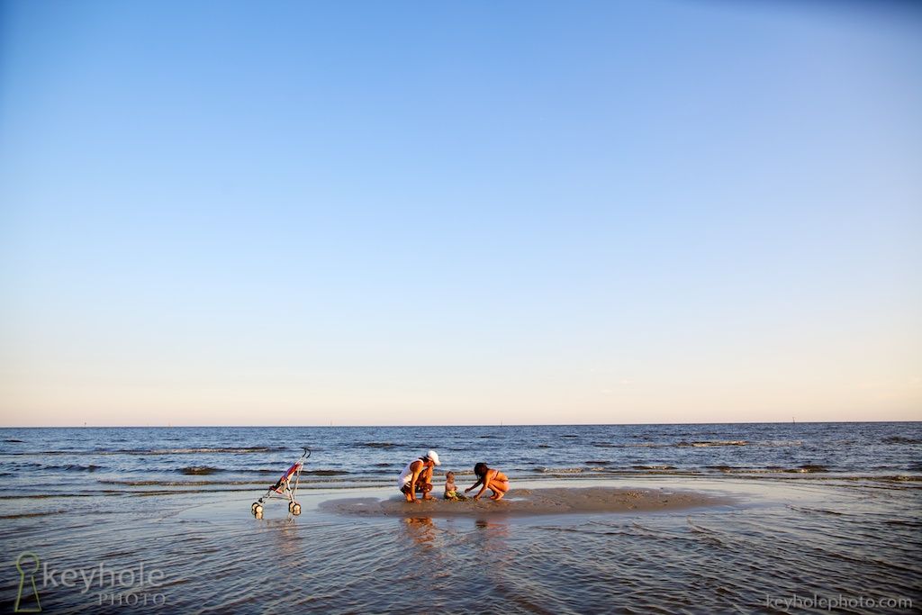 Family Members Play in Shallow Water at Beach