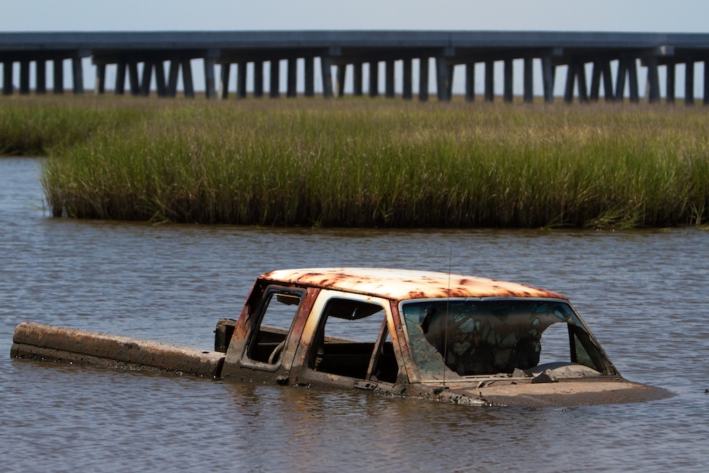 A truck lies submerged in the water along Louisiana Route 1 west of Grand Isle, La., Monday, Aug. 2, 2010.