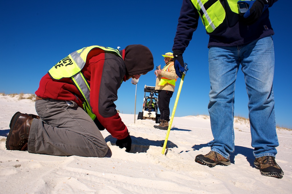 Crew Surveys Beach for Oil