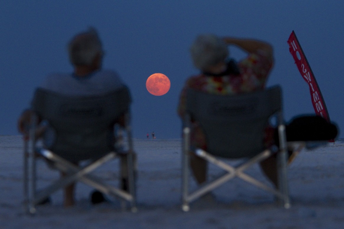People Watch the Harvest Moon Rise