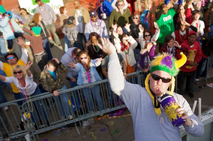 Revelers and parade-goers celebrate as the Joe Cain parade rolls through downtown Mobile, Ala., Sunday, February 14, 2010.