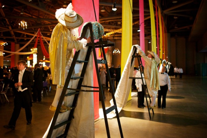 The Mobile Carnival Associaton's Knight Michael Damrich hangs the royal train of Royal Court member Virginia Inge for display during the King's Supper honoring King Felix III, Peter Cayce Sherman, Jr., February 13, 2010.