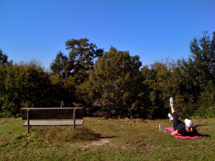 A woman stretches in the grass on the bluff above Mobile Bay in Fairhope, Ala., Sunday afternoon, Nov. 1, 2009.