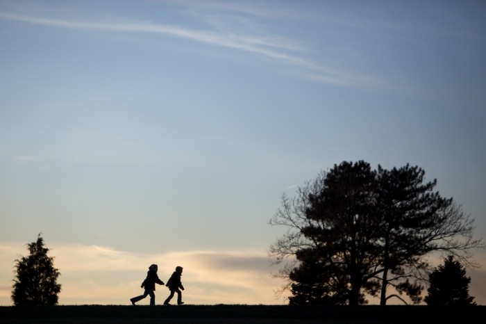 Sisters silhouetted at sunset