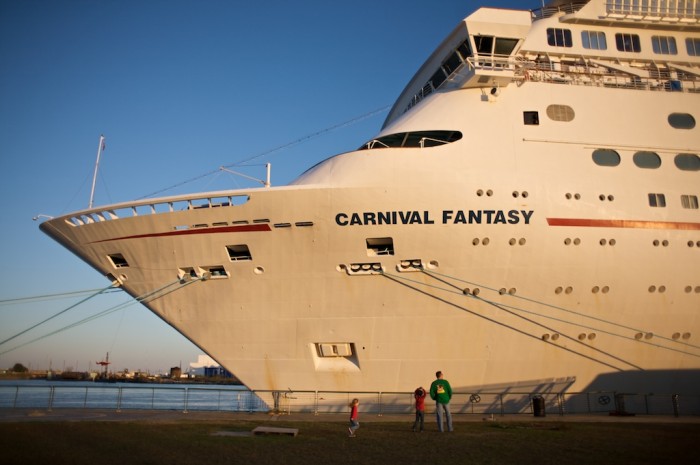 A family watches the cruise ship Fantasy get ready to depart the Alabama Cruise Terminal in Mobile, Ala., Saturday, Dec. 19, 2009.