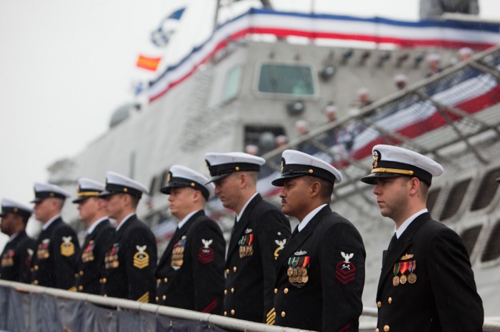 Crew members stand before the USS Independence during its commissioning ceremony in Mobile, Ala., Saturday, Jan. 16, 2010.