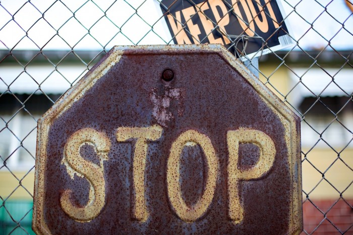 Rusted stop sign with keep out sign