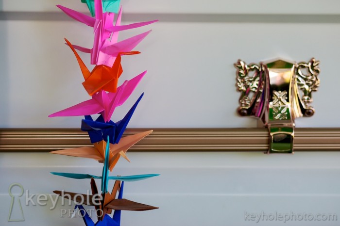 Paper cranes hang over the side of a coffin at a funeral in Mobile Memorial Gardens Cemetery in Mobile, Ala., Friday, April 9, 2010.