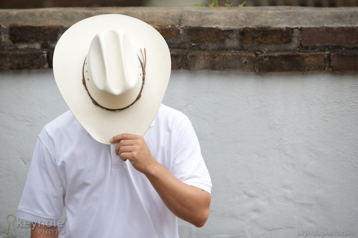 Cowboy hat in front of face