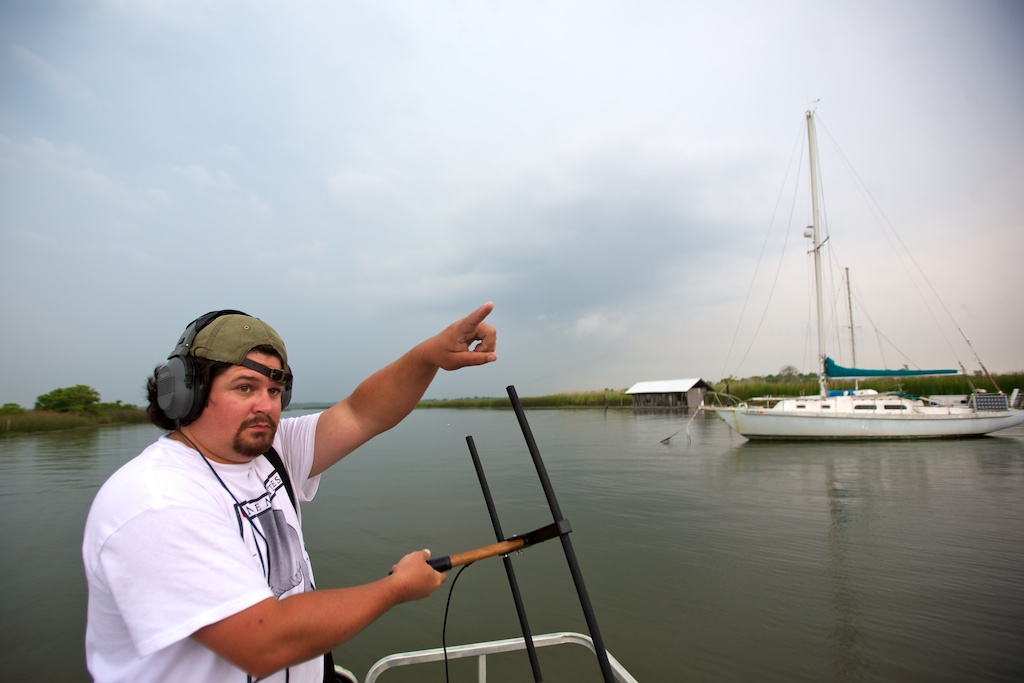 Allen Aven, graduate student in marine sciences at the Dauphin Island Sea Lab, listens to beeps from a VHF signal emitted by a tag tethered to tail of Bama, a 1000-pound manatee, which he is tracking in Scipio Creek off the Apalachicola River in Florida, Friday, June 18, 2010, in order to observe her behavior. Aven is closely monitoring Bama, and Bumpy, two manatees tagged by the Dauphin Island Sea Lab, for changes in their behavior since the Deepwater Horizon oil spill.
