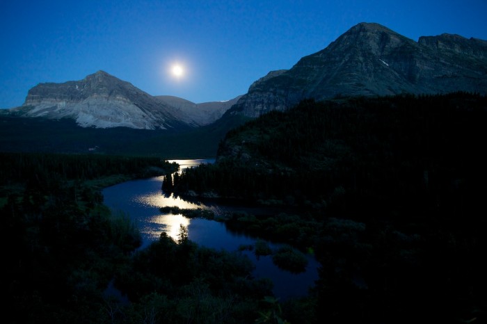 The moon rises over Glacier National Park