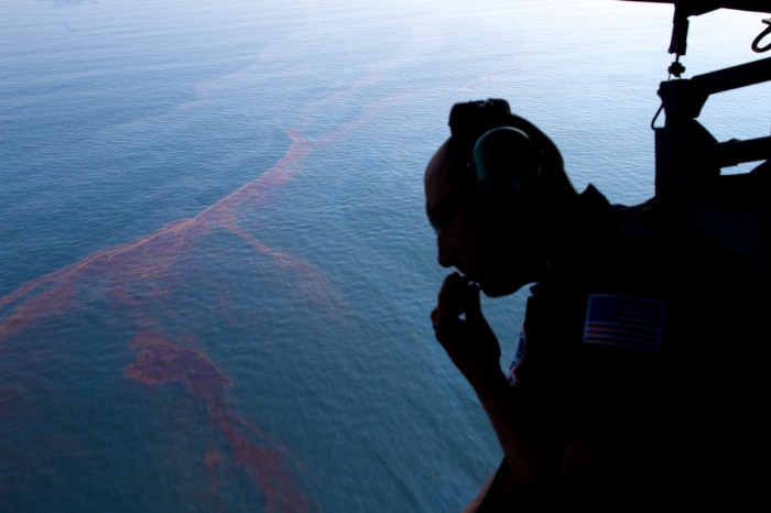Sean Hawes, a marine science technician with the U.S. Coast Guard surveys oil in the Gulf of Mexico south of Orange Beach, Ala., Tuesday, June 15, 2010. Oil from the Deepwater Horizon leaking well continues to spread out in the Gulf of Mexico.