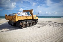 Heavy equipment operates as part of the beach cleaning effort at the Bon Secour National Wildlife Refuge in Gulf Shores, Ala., Friday, July 16, 2010.