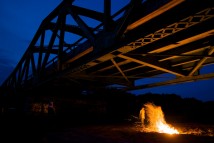 A campfire lights up the night under the Republican River bridge south of Red Cloud, Neb. Red Cloud, a town with a population of 935, down 17% in the 2009 census, has all the charm and challenges that face small towns in rural America.