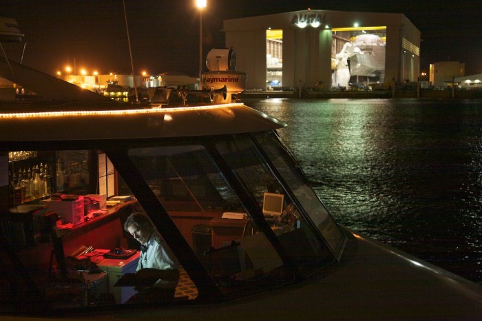 A boat operated is illuminated by a computer screen aboard the Harbor Lady as it awaits passengers Thursday, Feb. 15, 2011.