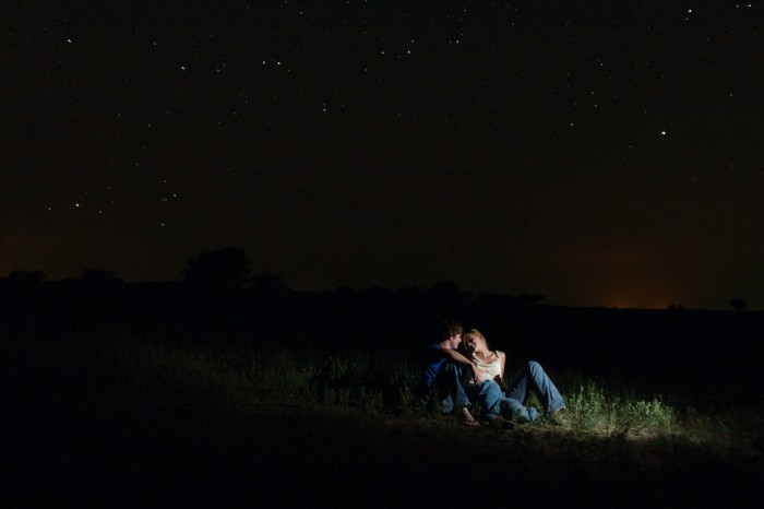 Marcie Hersh and Brendan Hathaway sit out under the stars in the country southeast of Red Cloud, Neb., Sunday morning, July 30, 2006, after a road party there Saturday night.