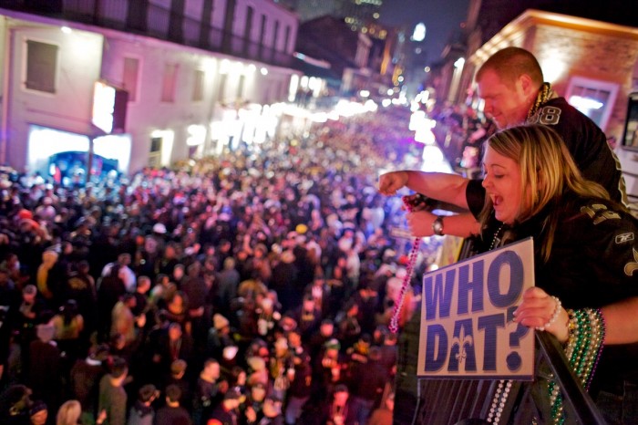Christy Morvant and LaRon Lumpkin celebrate in the early morning hours of Monday, Feb. 8, 2010, with thousands of people lining Bourbon Street in the French Quarter of New Orleans after the Saints won Super Bowl XLIV.