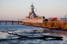 The USS Alabama battleship in Mobile Bay greets visitors to Mobile, Ala., as the sun rises Nov. 22, 2014.