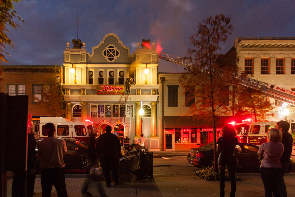 Firefighters work on the scene of a structure fire at Xcite hookah lounge in downtown Mobile, Ala., Sunday evening Nov. 30, 2014.